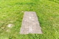 Ancient stone sundial among the green grass, outdoor, close up Royalty Free Stock Photo
