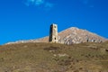 Ancient stone tower on the background of blue mountains Royalty Free Stock Photo