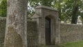 Stone wall and archway with a wooden gate Royalty Free Stock Photo