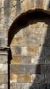 Ancient stone wall with archway in sunlight Royalty Free Stock Photo