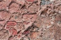 Ancient stone wall. Masonry of old red stones and bricks. Beautiful background. Royalty Free Stock Photo