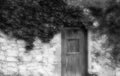 Ancient stone wall and a wooden closed door Royalty Free Stock Photo
