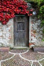 Ancient stone wall, with wooden closed door Royalty Free Stock Photo