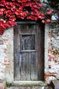 Ancient stone wall and a wooden closed door Royalty Free Stock Photo