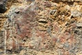 Ancient stone walls, brown and very old, with painted patterns on the surface Royalty Free Stock Photo