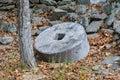 Ancient stone wheel of abandoned water mill to grind flour in old farm