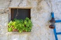 Ancient stone window of an old white stone house Royalty Free Stock Photo