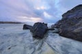 Ancient stones on the shores of cold Norwegian Sea at evening time. Lofoten islands. Beautiful Norway landscape Royalty Free Stock Photo