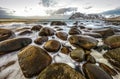 Ancient stones on the shores of cold Norwegian Sea at evening time. Lofoten islands. Beautiful Norway landscape. Royalty Free Stock Photo