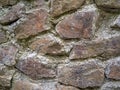 Ancient stonework. The stones are reinforced with old mortar. Uneven masonry ancient wall Royalty Free Stock Photo