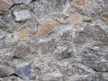 Ancient stonework. The stones are reinforced with old mortar. Uneven masonry ancient wall Royalty Free Stock Photo