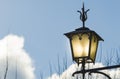 Ancient street lamp lit at dusk Royalty Free Stock Photo