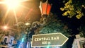 Ancient street lamp and pointer towards the pub at night