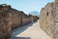 Ancient street with Mount Vesuvius in the background, in the ancient town of Pompeii, Italy Royalty Free Stock Photo