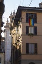 An ancient street of Old Town Citta Alta of Bergamo with rainbow flag on the balcony. Italy