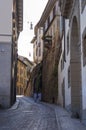 An ancient street of Old Town Citta Alta of Bergamo with two walking nuns. Lombardy, Italy Royalty Free Stock Photo