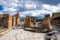 Ancient street is recovered in the middle of Roman ruins against the mountains