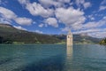 The ancient submerged bell tower of Lake Resia in Val Venosta, South Tyrol, Italy, emerges from the water