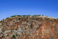 Ancient surrounding wall of Alanya fortress Turkey over a steep cliff - bottom view. Medieval stone fort with towers and Royalty Free Stock Photo