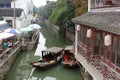 Ancient tea house and boats in a canal in the ancient water town Suzhou, China