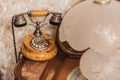 An ancient telephone and a lamp on a wooden table Royalty Free Stock Photo