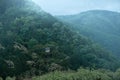 Ancient Japanese Temple Nestled in Green Mountains in Royalty Free Stock Photo