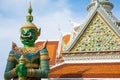 Ancient temple guardian in front of Temple of Dawn Wat Arun Buddhist Temple is green demon giant statue.