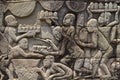 Ancient temple stone carved bas-relief in Angkor Wat. Cooking people bas-relief closeup. Angkor Wat complex Bayon temple Royalty Free Stock Photo