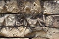 Ancient temple stone carved bas-relief in Angkor Wat. Smiling woman dancing apsara closeup. Royalty Free Stock Photo