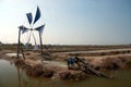 Ancient Thai traditional water wheel pump and wind mill. Royalty Free Stock Photo