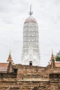 ancient thai white pagoda is standing front of red brick ancient ruins chapel in Ayutthaya, Thailand Royalty Free Stock Photo
