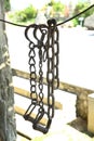 stirrup with which the rider mounts a horse . Ancient thick chains. Iron horse saddle . Royalty Free Stock Photo