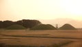 Ancient Tombs of Kings of Silla dynasty in Gyeongju, tumuli royal park at sunset