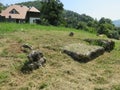 Ancient tombstone with cross in local cemetery Royalty Free Stock Photo