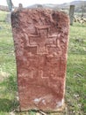 Ancient tombstone with cross in local cemetery Royalty Free Stock Photo