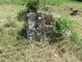 Ancient tombstone with cross in local cemetery Royalty Free Stock Photo