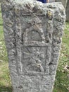 Ancient tombstone with cross in local cemetery Royalty Free Stock Photo