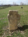 Ancient tombstone with cross in local cemetery Royalty Free Stock Photo