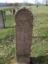 Ancient tombstone with cross in local cemetery Royalty Free Stock Photo