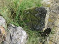 Ancient tombstone with symbol in local cemetery Royalty Free Stock Photo