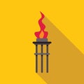 Ancient torch burning with bright flame on yellow background