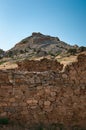 Tower on top of rock against background of ruins medieval stone fortress wall - tourist attraction in Sudak, Crimea