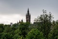 The ancient tower of the Gilbert Scott Building of University of Glasgow behind the green Kelvingrove Park in Scotland Royalty Free Stock Photo