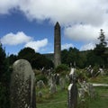 An ancient tower and headstones in Ireland Royalty Free Stock Photo