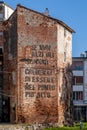 An ancient tower of the walls of Cascina, Pisa, Italy, with the exhortation to look higher Royalty Free Stock Photo