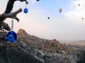 Ancient town Uchisar with evil eye charms and balloons Royalty Free Stock Photo