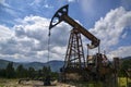 Ancient traditional classical oil pumps of Ukrainian oilmen in the Carpathians in the background of mountains