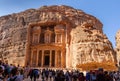 Ancient treasury Al-Khazneh in Petra with a crowded entrance on a bright sunny day