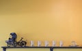 Ancient tricycle, many thumbtack glasses and a cup on wooden wall shelves. Royalty Free Stock Photo