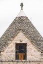 Ancient Trullo roof in the countryside, traditional old house and old stone wall in Puglia, Italy Royalty Free Stock Photo